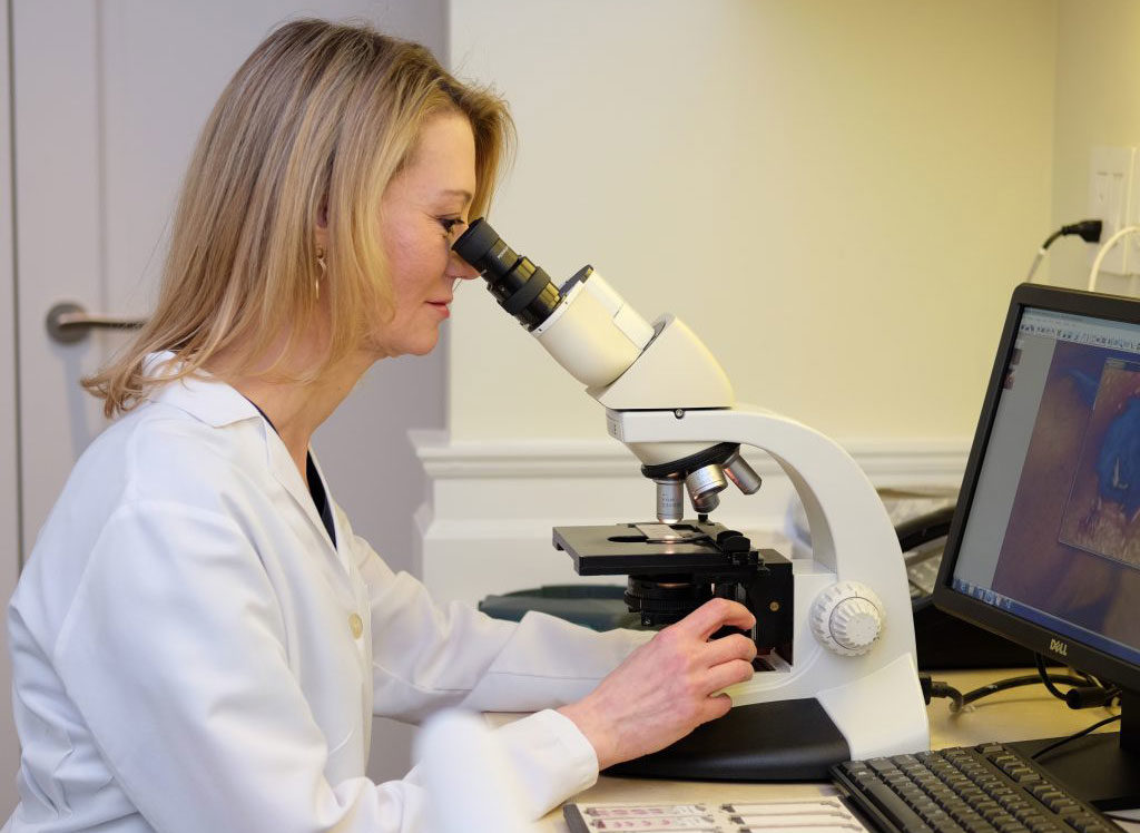 Dermatologist with Microscope Dermatologist examine mohs surgery