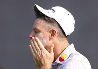 Justin Rose of England applies sunscreen